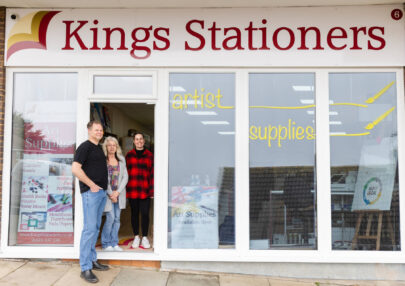 Outside Kings Stationers retail shop with staff